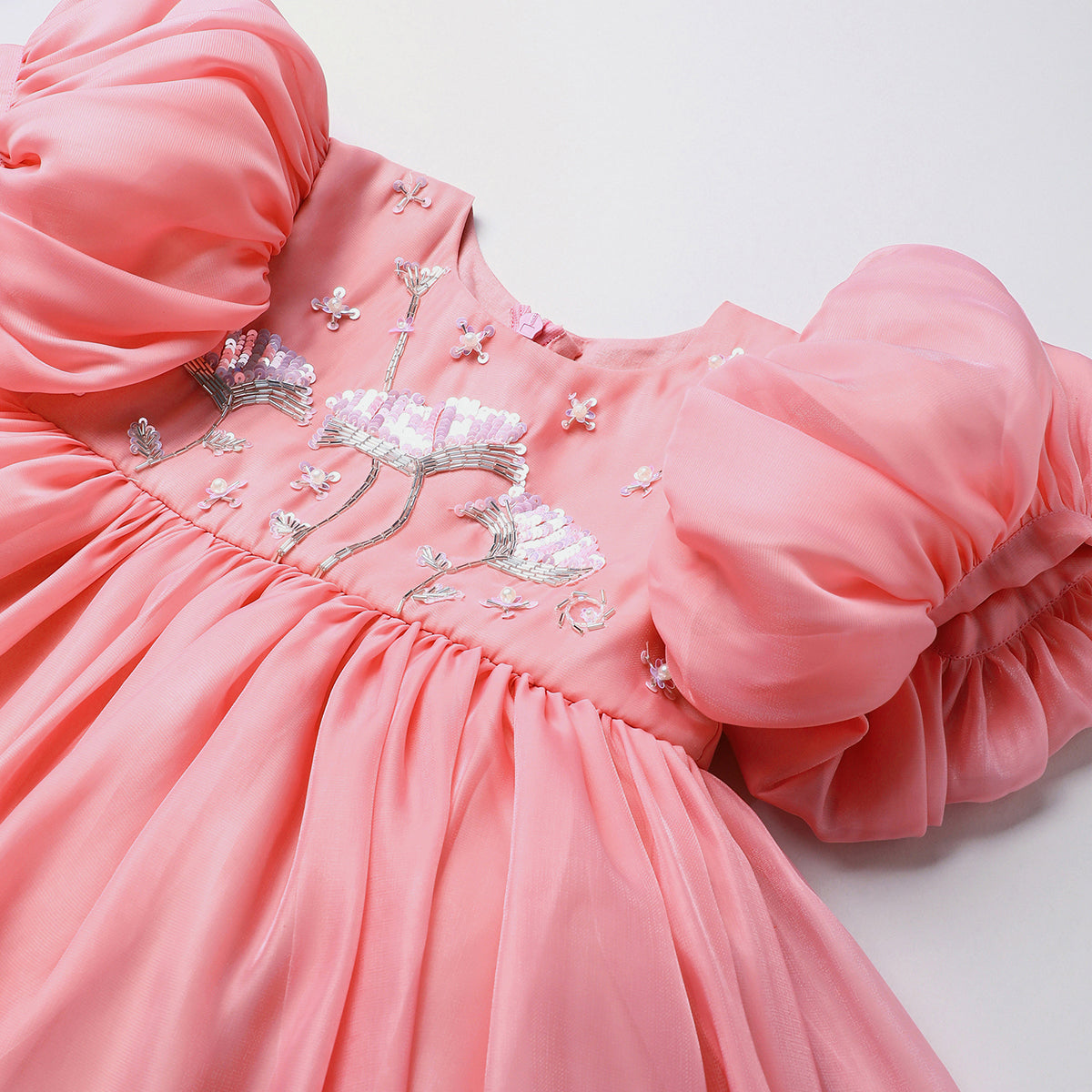 Baby pink tissue girls party dress with puff sleeves & floral embroidery