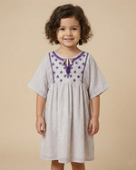 Load image into Gallery viewer, Girl wearing neutral beige premium cotton dress with embroidered detailing