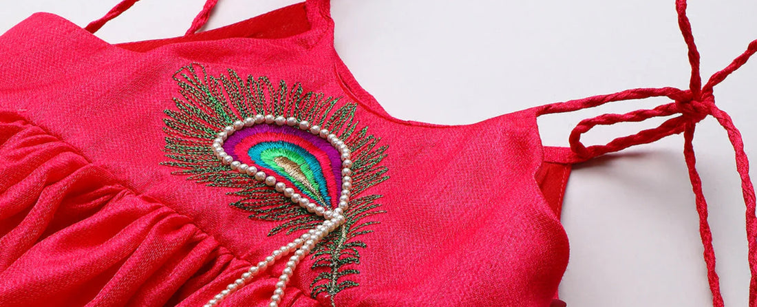 Luxury kidswear pink dress with peacock feather embroidery and pearl detail