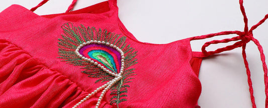 Luxury kidswear pink dress with peacock feather embroidery and pearl detail