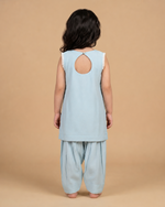 Load image into Gallery viewer, Girl wearing a pastel Chanderi peplum kurta with floral embroidery and matching dhoti pants for festive occasions
