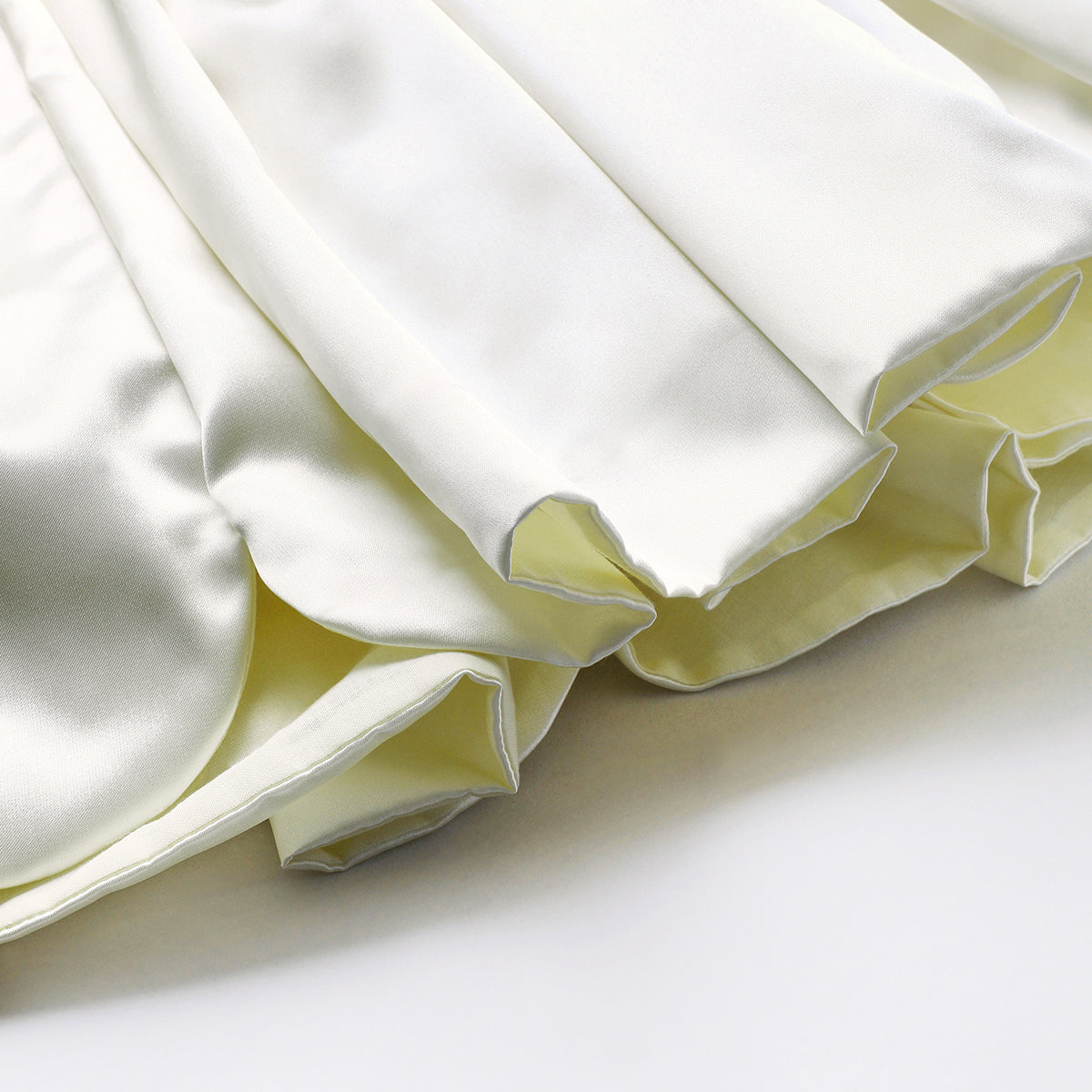 Ivory dress for baby girls features a delicately hand embroidered and scalloped hemline