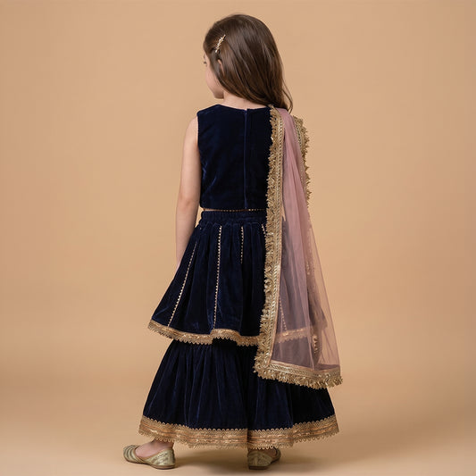 Girls navy blue velvet lehenga set with zardozi hand-embroidered crop top, gold border detailing and sheer dupatta.