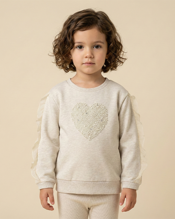 Girl wearing ecru melange cotton elastane sweatshirt with heart detail