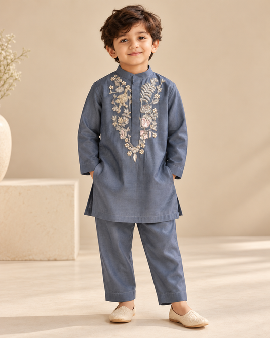 Boys slate blue Chanderi kurta and trouser set with intricate pearl and zardozi floral embroidery on the front.