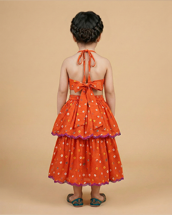 Orange bandhani embroidered v neck top with layered lehenga skirt for girls